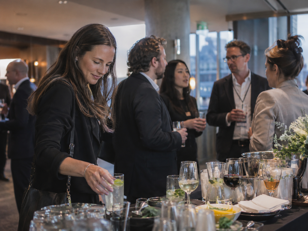Employees socializing at a corporate event with alcoholic and alcohol-free drinks available
